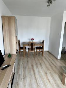 a dining room with a wooden table and chairs at Metro Central 3 Rooms Apartment in Warsaw +15 photos