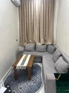 a living room with a couch and a table at Villa ghmate in El Kriet