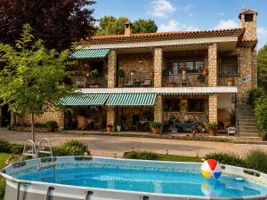 a house with a pool in front of a house at Villa Sanz in Cuenca