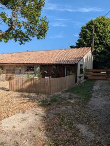 a house with a fence in front of it at chambre aux moutons in Saint-Méard-de-Gurçon