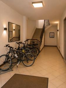 a row of bikes parked in a room with a staircase at LOFT EMILIA - la tappa perfetta tra Bologna e Ravenna - SELF CHECK-IN in Castel Bolognese
