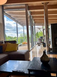 a living room with a couch and a table at PaderCityLoft- lichtdurchflutet und privat mit Kamin-Dachterrasse-Sauna-Außendusche im Atrium in Paderborn +13 photos