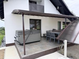 an outdoor patio with a grill and a table at Liveza House in Miklavž pri Ormožu