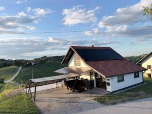 a house with a solar roof on a driveway at Liveza House in Miklavž pri Ormožu