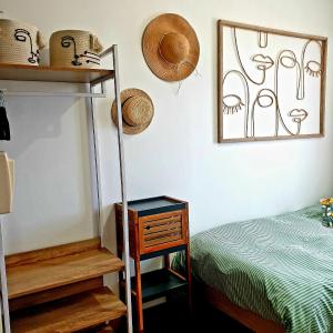 a bedroom with a bed and hats on the wall at La Villa Turquoise in Le Tréport