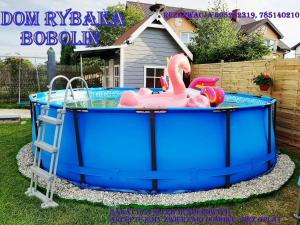 a large inflatable swimming pool with a pink flamingo in it at Dom Rybaka Bobolin in Bobolin