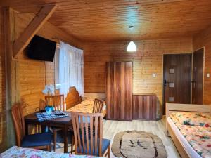 a room with a table and a dining room at Dom Rybaka Bobolin in Bobolin