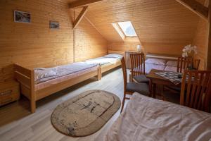 a small room with two beds and a table at Dom Rybaka Bobolin in Bobolin +8 photos