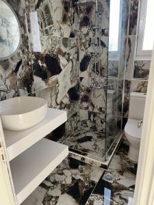 a bathroom with a sink and a toilet at Villa Lagosta in Város +39 photos