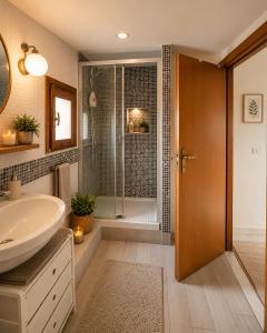 a bathroom with a shower and a sink at Appartamentino Mansardato in Pedara