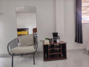 a room with a chair and a wooden table at Cuarto en galápagos in Puerto Baquerizo Moreno +16 photos