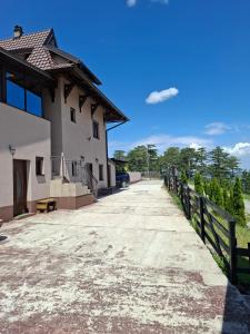 a driveway leading to a house with a fence at Ribnica in Ribnica