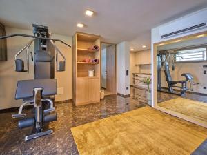 a gym with two treadmills and two exercise bikes at Luxury Apartments La Baia - Penthouse in Torri del Benaco