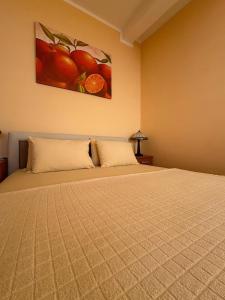 a bedroom with a bed with a painting on the wall at Sunset Residence Blizikuce in Budva +48 photos