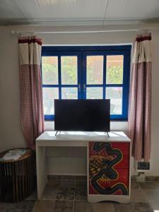 a desk with a laptop on it in front of a window at Kellaki Village House in Kellaki