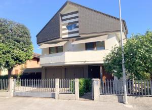 a house with a fence in front of it at Ciconi Apartment in Gorizia