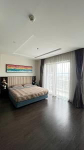 a bedroom with a bed and a large window at Studio Sapphire Hạ Long View Biển in Ha Long +19 photos