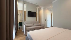 a bedroom with a bed and a couch at Art Hotel Vlora in Vlorë