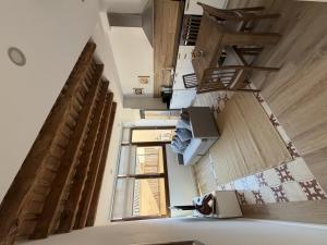 a room with stairs and a person sitting in a chair at Apartamentos_Lovely_Rooms_Vic in Vic