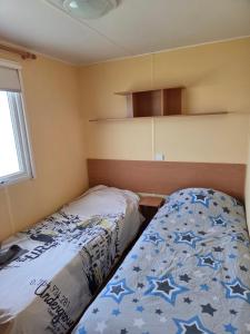 a small bedroom with a bed with stars on it at ferme de castel pouzouilh in Le Fossat