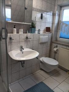 a bathroom with a sink and a toilet at Zum Graureiher in Heringsdorf