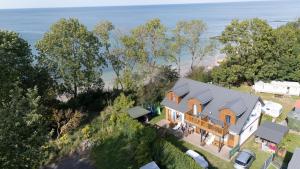 an aerial view of a house with the ocean in the background at Morena in Jarosławiec