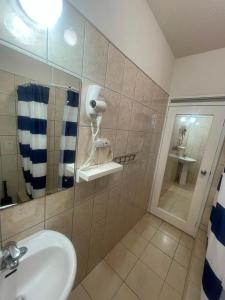 a bathroom with a sink and a mirror at Cozy Suite, Wifi, Ac in Bedroom & 1 Minute Walk to West Coast Beach! in Saint James