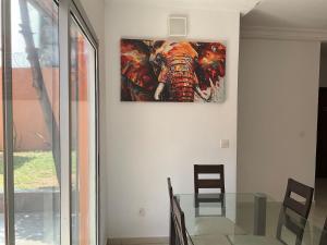 a painting of an elephant hanging on a wall at Villa Terracotta - Riviera Synacassi - 3 chambres in Abidjan +16 photos