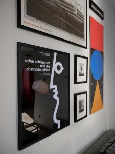 a wall with posters and pictures on a wall at Das Bauhaus-Eck in Dobritz