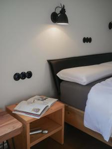a bedroom with a bed and a table with a book at Das Bauhaus-Eck in Dobritz