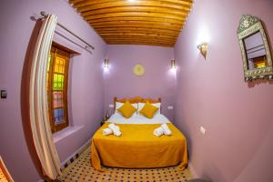 a bedroom with a bed with two towels on it at Riad Mozaik Fes in Fez