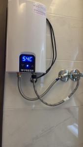 a clock is hooked up to a machine on a counter at Sunrise View K8 Apartments in Hurghada +75 photos