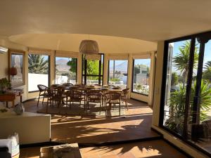 a dining room with a table and chairs at Villa Dora Bella Lanzarote in Nazaret