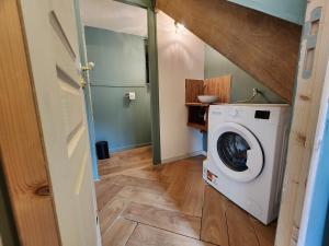 a laundry room with a washer and dryer at La Pastellière - Combrand in Combrand
