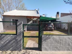 a fence with a gate in front of a house at Las Tres Reinas A in Colorado River
