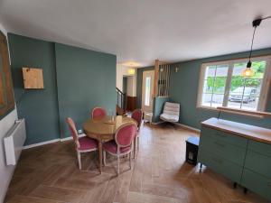 a dining room with a table and chairs at La Pastellière - Combrand in Combrand
