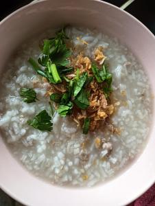 a bowl of rice with meat and greens on top at Pai sunrise camping resort in Pai