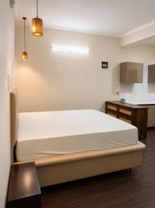 a bedroom with a large white bed in a room at Astha lodge in Solan