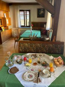 a table with plates of food on top of it at Ferienwohnungen in Schönmünzach in Baiersbronn