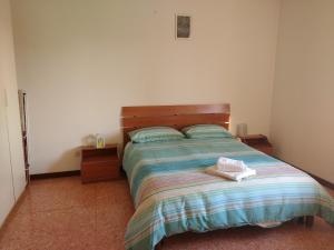 a bedroom with a bed with a wooden head board at ANDREA - Chiassi in Brescia