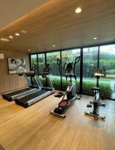 a gym with several treadmills and elliptical machines at Vay Pothisan in North Pattaya