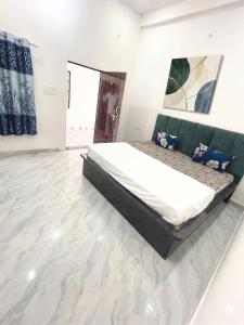 a bedroom with a large bed in a white room at Hotel bhagwati palace in Orchha
