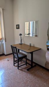 a wooden table with a chair and a mirror at ANDREA - Chiassi in Brescia