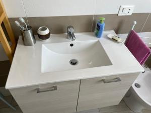 a bathroom with a white sink and a toilet at ANDREA - Chiassi in Brescia