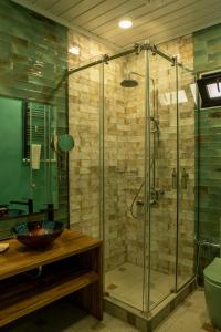 a bathroom with a shower with a glass door at SaguleResort in Monasteri +98 photos