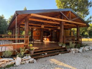 a wooden gazebo with a wooden deck at Wilgano in Rvaši