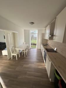 a kitchen with a table and a dining room at Landhaus Bea in Rabenkirchen-Faulück +18 photos