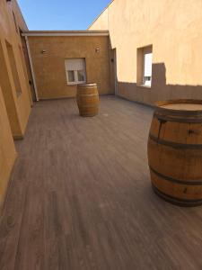 two wooden barrels sitting on the floor of a building at Apartamento 7 in Alcuéscar
