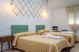 two beds in a room with white walls at Apartamento 7 in Alcuéscar