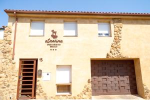 a building with a sign on the side of it at Apartamento 7 in Alcuéscar